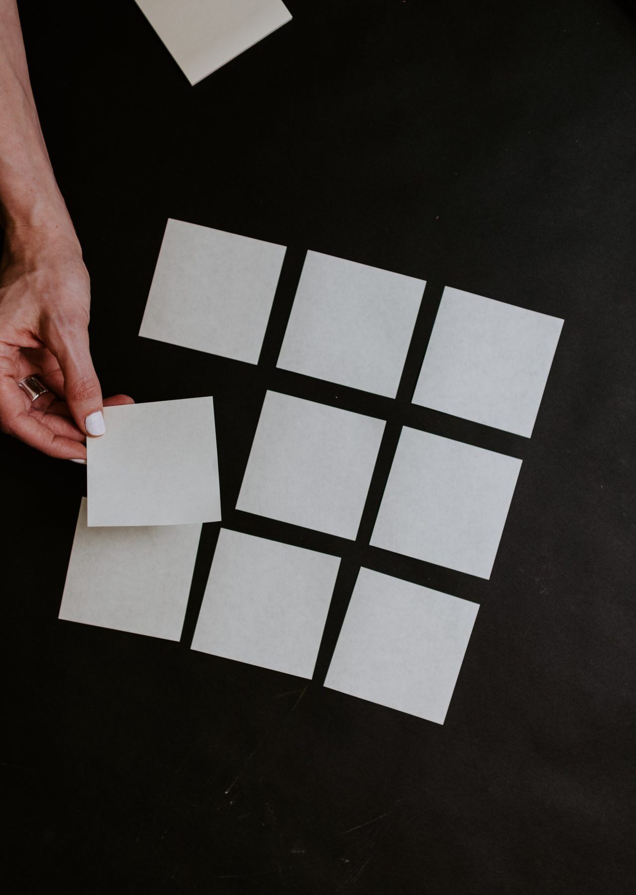 person holding white and black checkered card